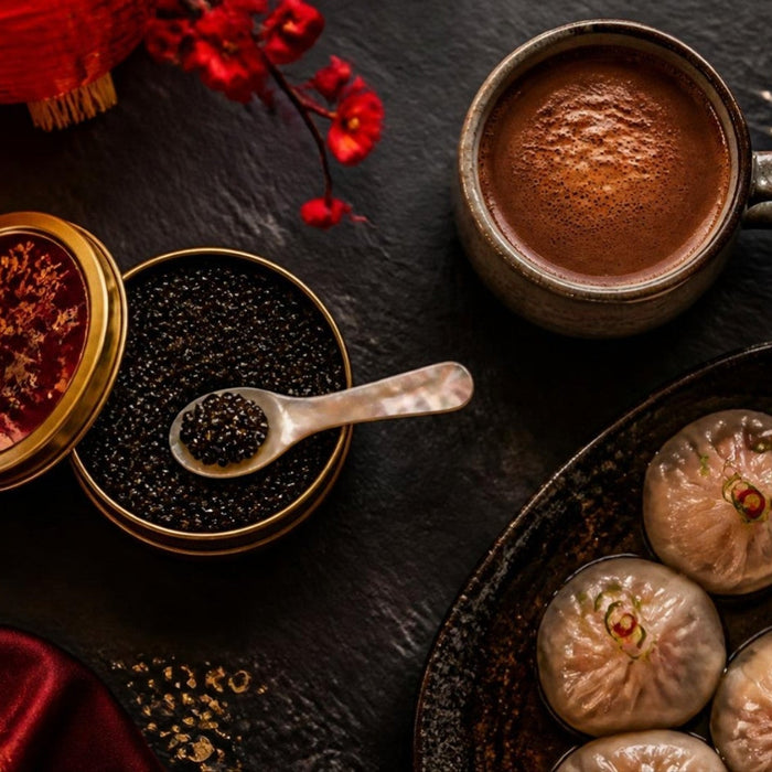 Dumplings, caviar and hot cocoa on a dark table for Lunar New Year