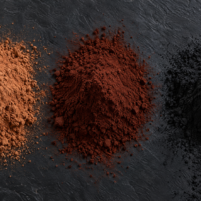 Natural, Dutch-processed and black cocoa powder side by side showing the color difference