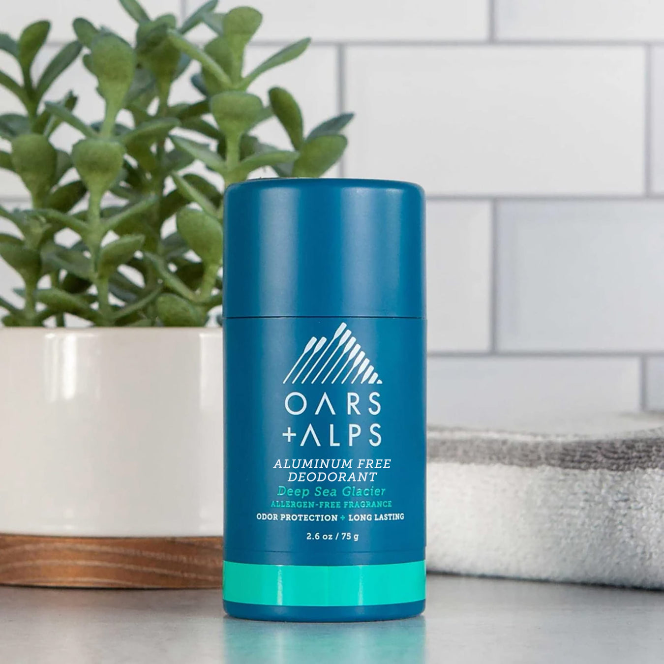 Oars + Alps grooming products for chefs on a stainless kitchen counter
