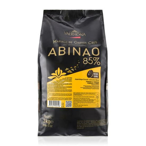 Bag of VALRHONA Abinao 85% Feves, intense dark chocolate discs for bold flavor in baking and confections.