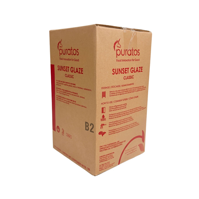 A brown cardboard box of puratos Sunset Glaze Classic B2, featuring red text and branding, photographed on a clean white background.