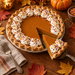 Pumpkin pie with a whipped cream border dotted with fall jimmies (AI-generated lifestyle photo)