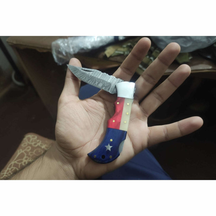 Handmade Damascus Folding Knife – Tricolor Resin Handle (Red, White & Blue) with Leather Sheath