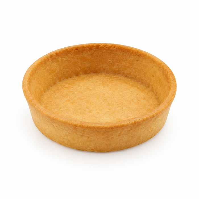 Single round golden neutral tart shell on a white background